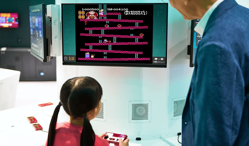 An image of a child playing Donkey Kong on the Nintendo Museum interactive classic games exhibit which was speculated to be ran on emulators on the Nintendo Museum emulator controversy.