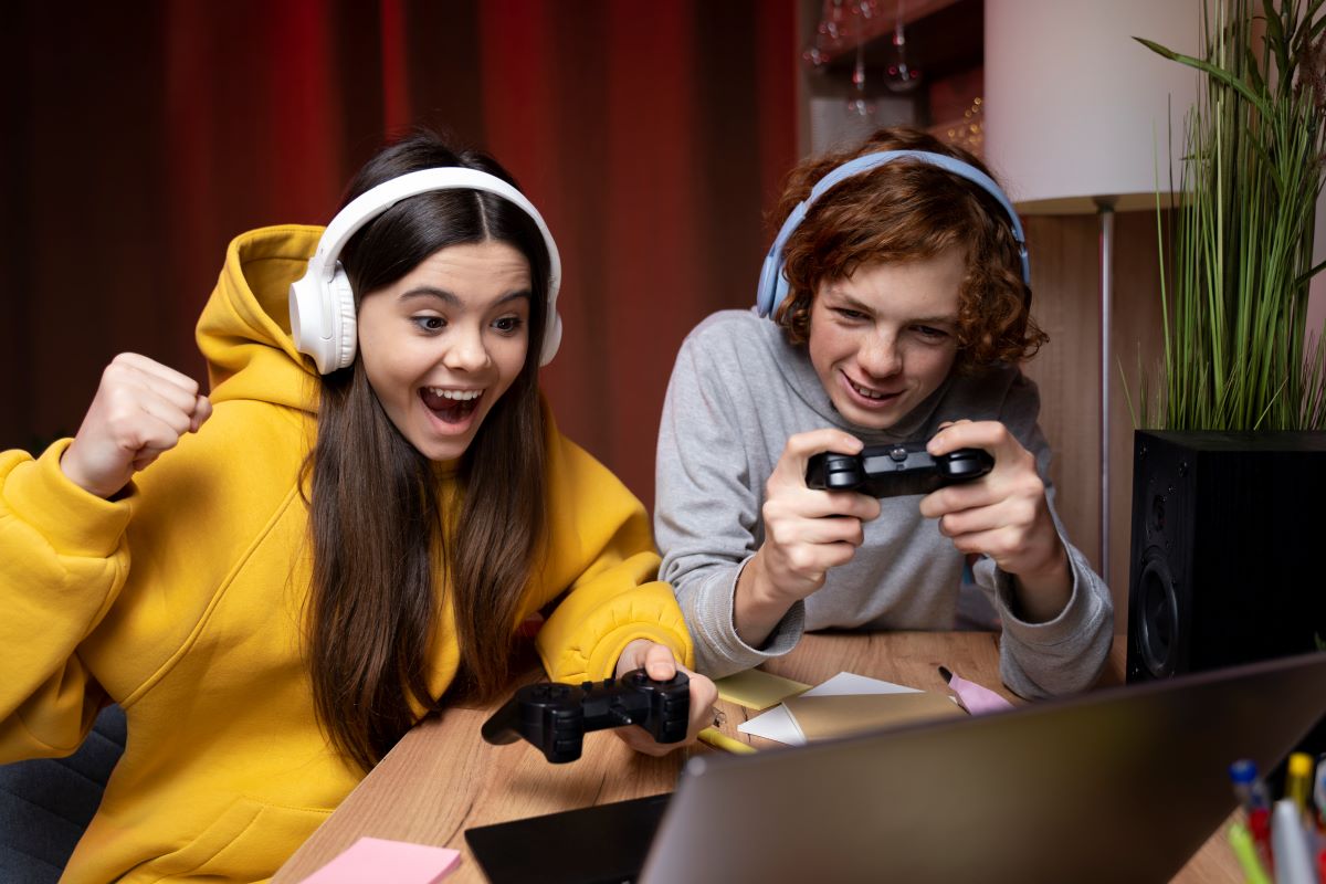 image of two friends playing video games as they enjoy the upcoming black friday deals 2024